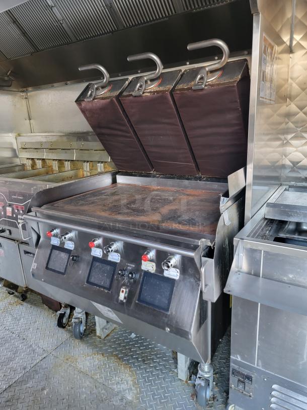 Rock Solid Cargo 28' mobile kitchen trailer with commercial griddle, fryers, and refrigeration. Equipped for high-volume use.