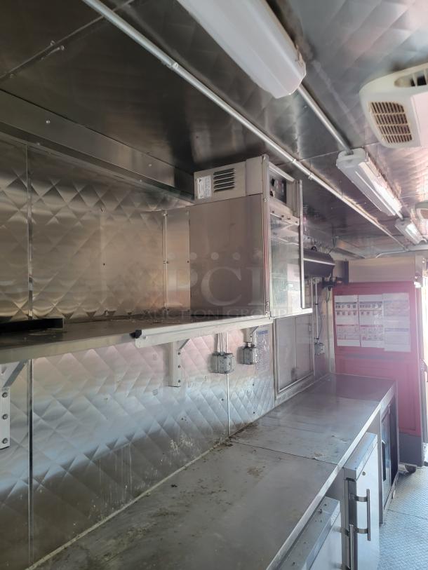 28' Rock Solid Cargo mobile kitchen trailer interior; stainless steel countertops, refrigeration units, and ventilation system.