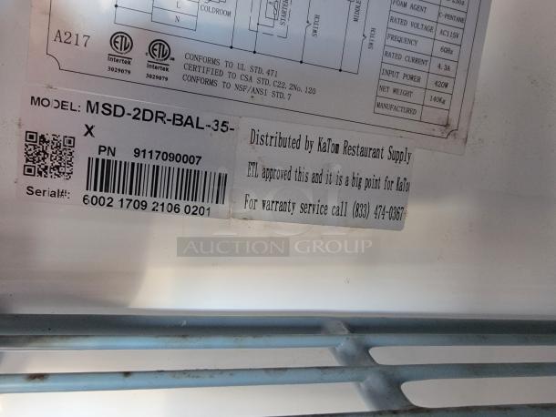 Label inside the mobile kitchen trailer showing model MSD-2DR-BAL-X and serial number 6002170921060201, distributed by KaTom Restaurant Supply.