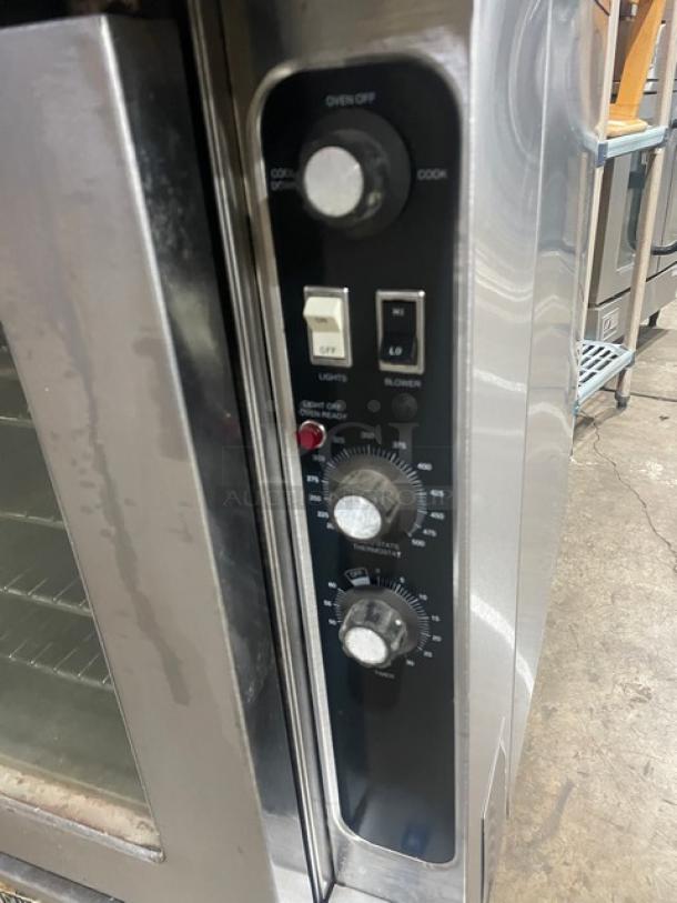 Blodgett stainless steel double convection oven, electric, thermostatic control, wired rack, on legs, control panel detail.