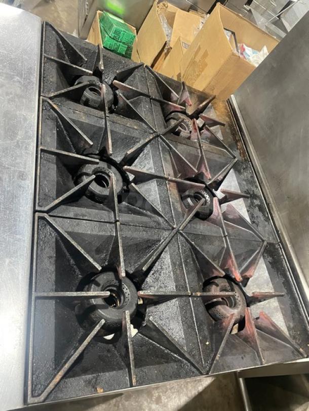 Vulcan 36SF-6BN commercial 6-burner stainless steel gas stove with convection oven, backsplash, salamander shelf, and casters.