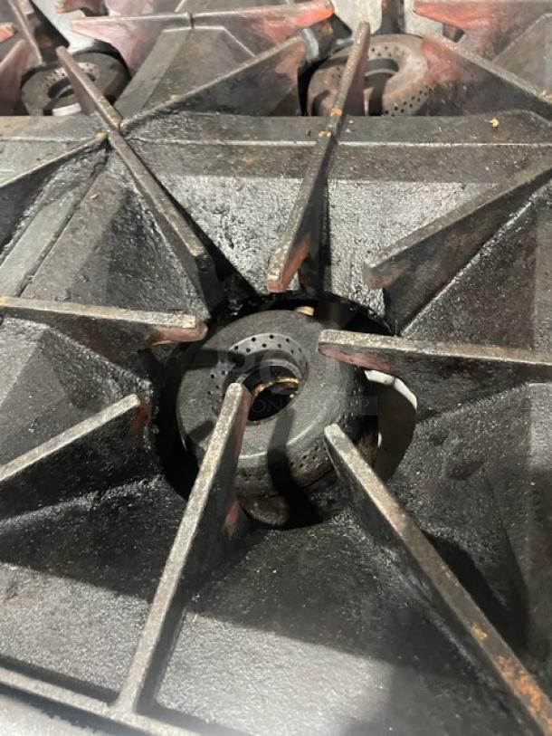 Vulcan 6 burner stove grates in used condition, part of model 36SF-6BN commercial gas stove, showing heavy-duty iron build.