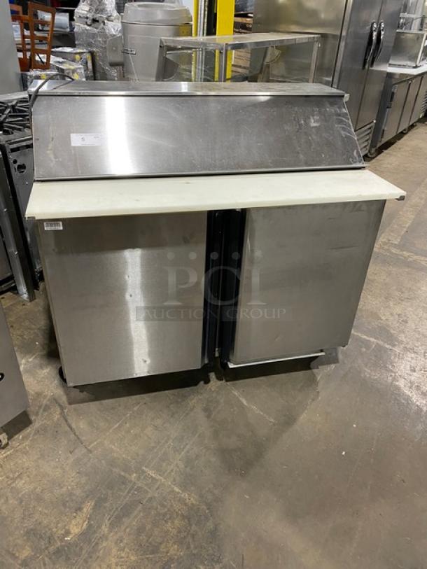 Silver King stainless steel 2-door refrigerated prep table, model SKEPT4812SD1BM, with cutting board, on casters.