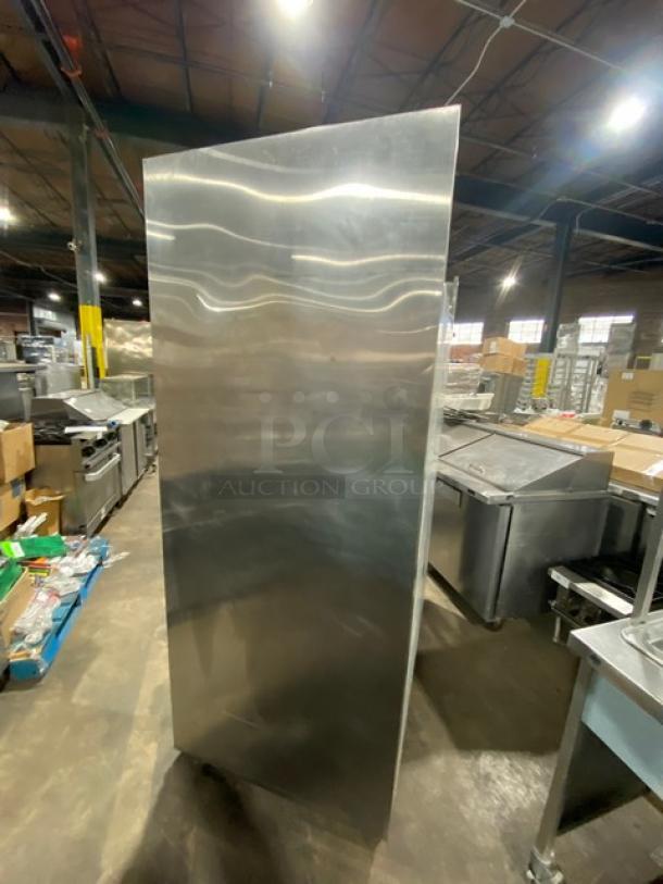 Traulsen Spec Line Series stainless steel half-door refrigerator, model AHT232WUTHHS, with casters in warehouse setting.