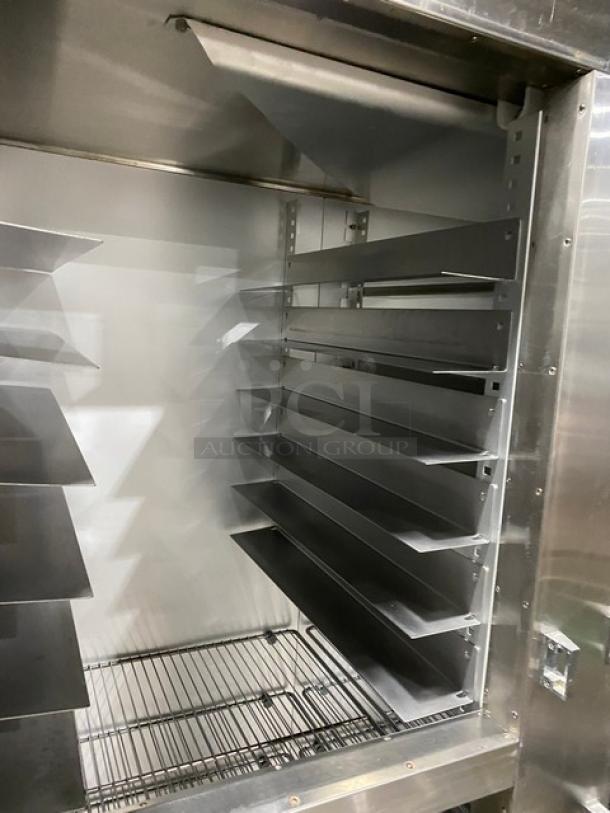 Traulsen Spec Line commercial fridge, model AHT232WUTHHS, stainless steel, half-door, chrome rack, pan slides, on casters.