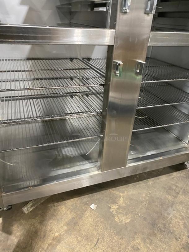 Traulsen Spec Line stainless steel double section reach-in refrigerator, model AHT232WUTHHS, with chrome racks, on casters.
