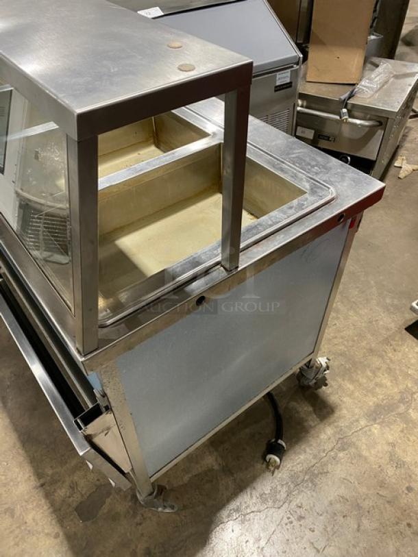 Atlas Metal 4-well stainless steel steamtable with sneeze guard, folding tray slide, on casters. Model WIHD&M4, 208V 1 Phase.