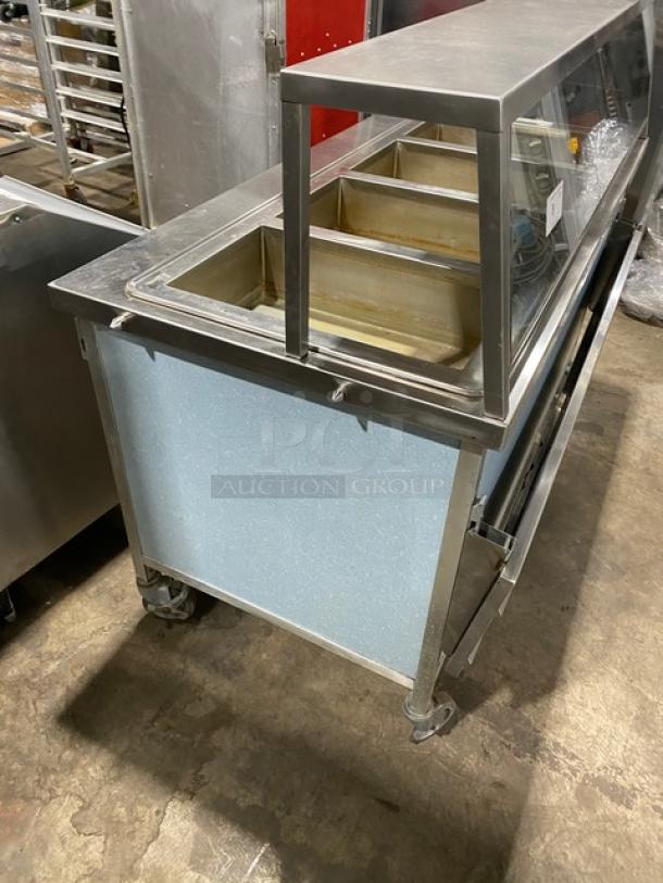 Atlas Metal WIHD&M4 stainless steel electric 4-well steamtable with sneeze guard, folding tray slide, on casters, 208V.