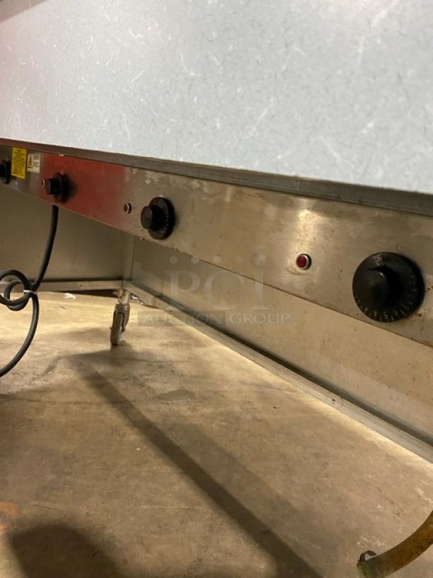 Atlas Metal 4-well stainless steel steam table, model WIH-D&M-4, with sneeze guard, folding tray slide, on casters.