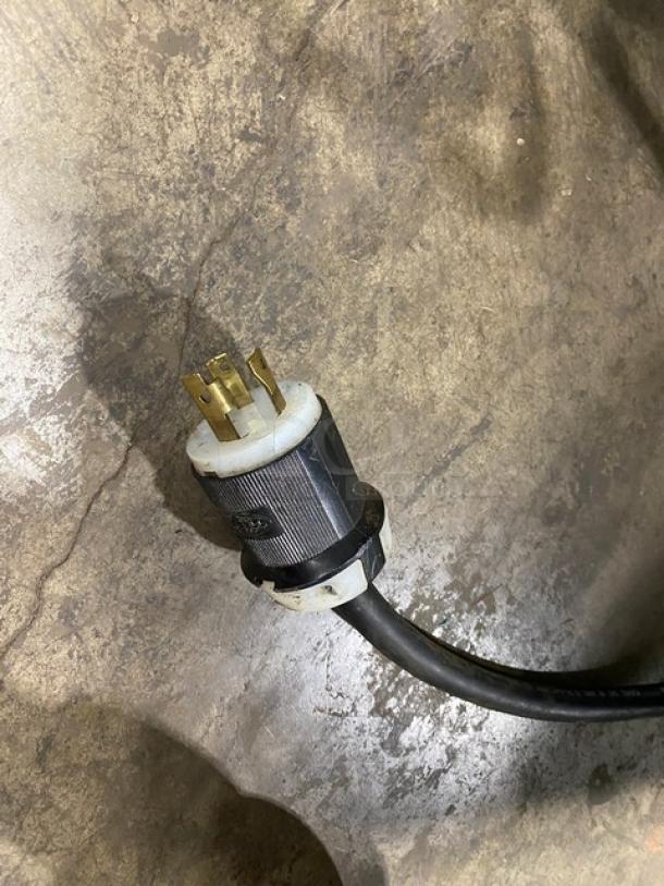 Close-up of an electrical plug for the Atlas Metal WIHD&M4 hot food steamtable, showing a 208V, 1-phase connection.