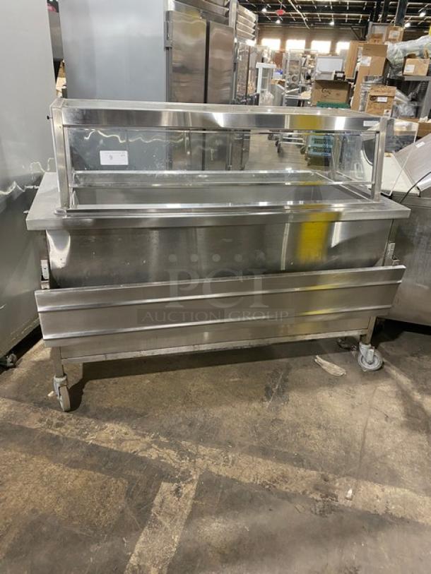 Delfield stainless steel refrigerated cold food bar, model N8156B, with sneeze guard, tray slide, undershelf, on casters.