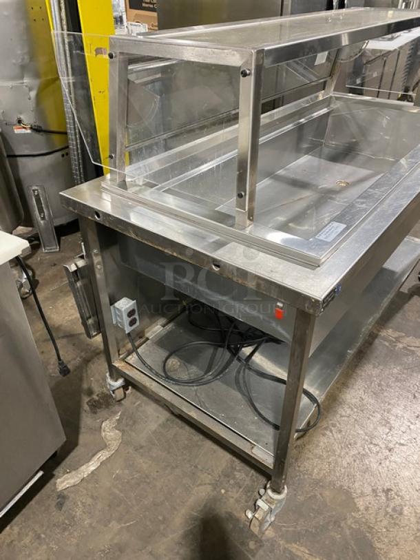 Delfield N8156B stainless steel refrigerated salad bar, sneeze guard, folding tray slide, single undershelf, on casters, 115V.