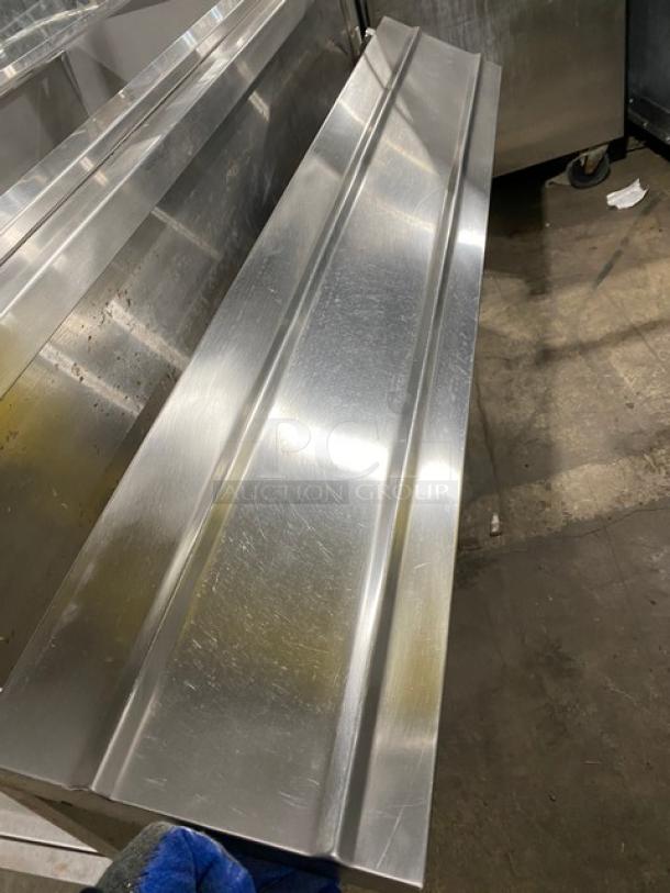 Delfield N8156B stainless steel refrigerated buffet with sneeze guard, folding tray slide, single undershelf, on casters.