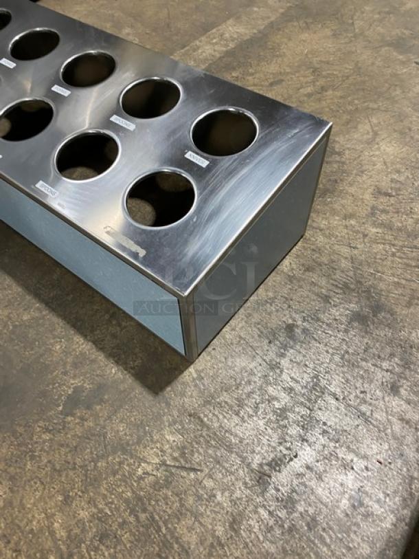 Stainless steel countertop utensil organizer with 10 compartments, visible labels, excellent condition.