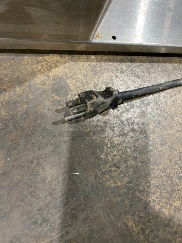 Power cord for Bunn Infusion Series ITCB-DV Tea/Coffee Brewer, showing a three-prong plug on a textured surface.