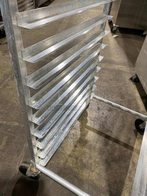 Commercial stainless steel pan holding/transport rack on casters, excellent condition, 10 slots, sturdy construction.