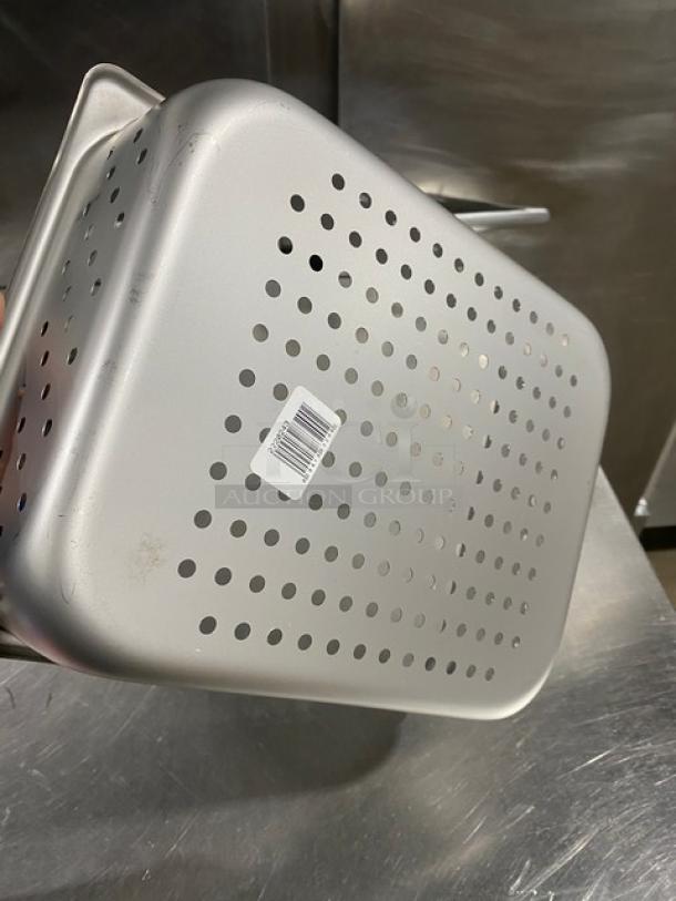New commercial stainless steel perforated half-size pan, 4" deep, model 2220243, with barcode sticker visible.