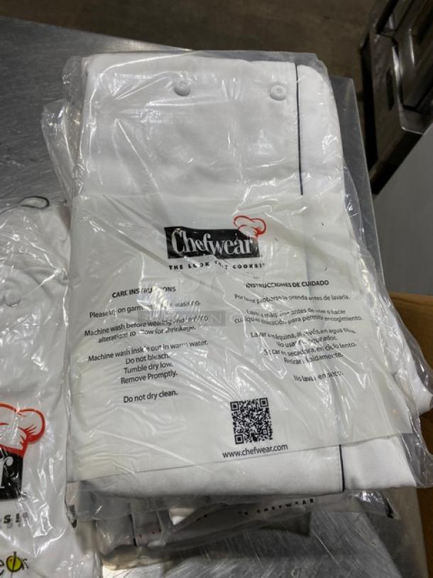 New Chefwear chef coat, model CW5690CWP1, white with black piping, size 5X, in original packaging with care instructions.