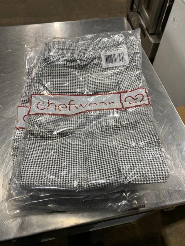 New Chefwear black & white XL-size chef pants, model CW3200-CW11, packaged in plastic. Brand logo and barcode visible.