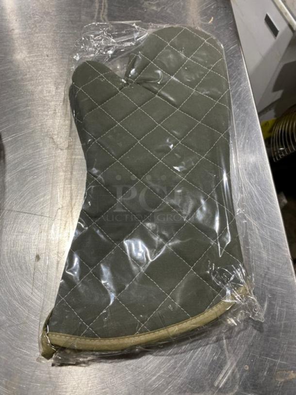 Johnson-Rose green fire-resistant oven mitts in packaging, new condition, quilted pattern for commercial use.
