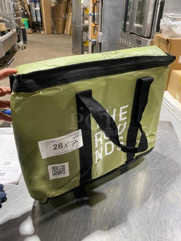 Green "The Rounds" insulated delivery bag, new condition, black handles, zip closure, visible label with auction details.