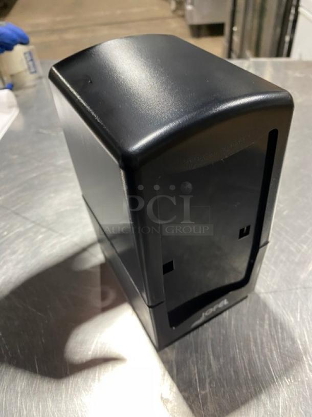 Jofel black tabletop tall-fold napkin dispenser, new condition, sleek design, durable plastic, branding visible on the front.