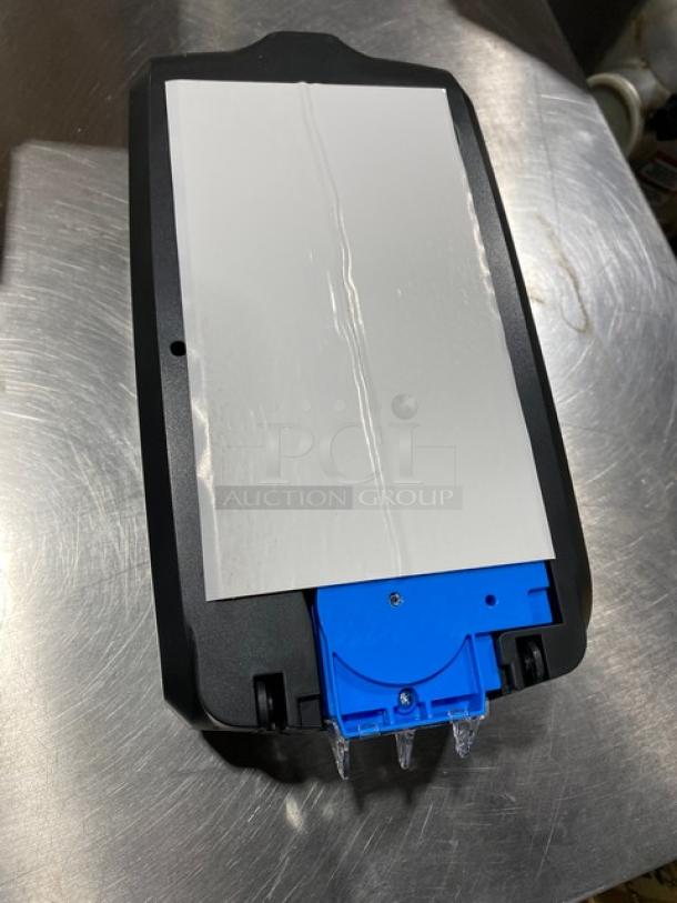 Ecolab Nexa Series touch-free hand hygiene dispenser, black, new condition, features a blue internal component.