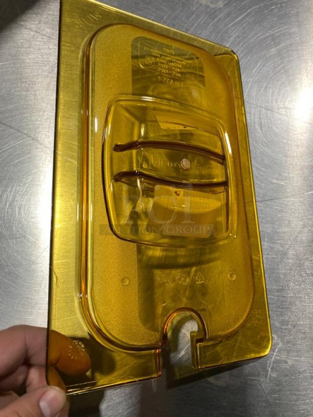 Rubbermaid Commercial Yellow Polycarbonate 1/4 Size Food Pan Cover, Model G214P86AMBR, shown in excellent condition.