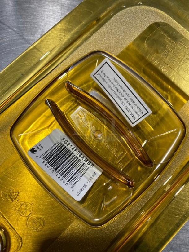 Rubbermaid Commercial yellow polycarbonate 1/4 size food pan cover, model G214P86AMBR. Visible labels and model markings.