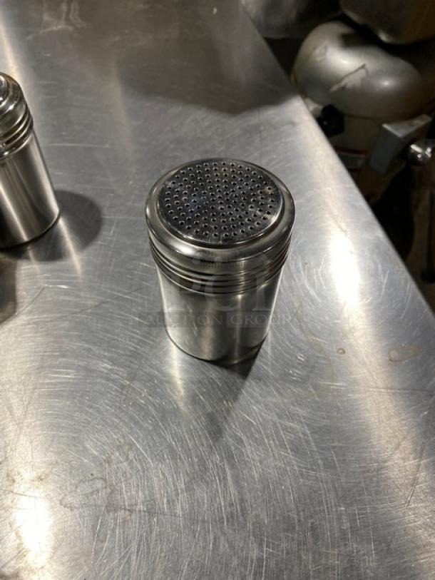 NEW ABC Commercial Stainless Steel 10 Oz Dredge/Shaker, Model SSD12, in mint condition on metal surface.