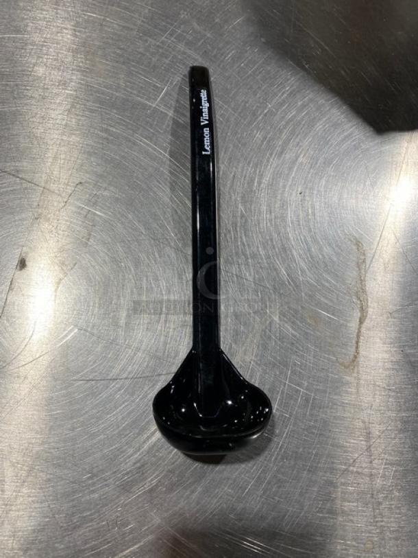 Carlisle 9.5" black ladle, model 02955979, labeled "Lemon Vinaigrette." New condition, glossy finish.