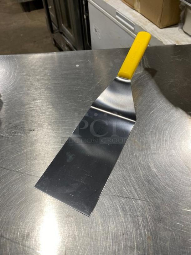 Dexter Russell 8"x4" hamburger turner, stainless steel, model P94859, with yellow grip handle, new condition.
