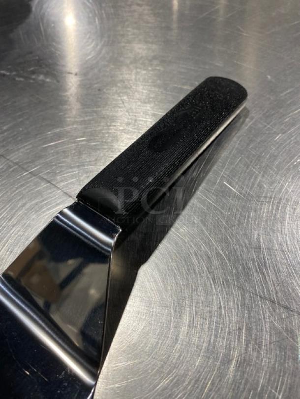 Dexter Russell Sani-Safe Series stainless steel hamburger turner, model S286-4, with black grip handle. New condition.