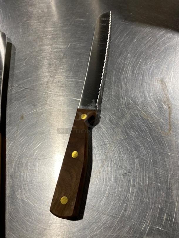 Dexter Russell 8" bread knife, model 628, with stainless steel blade and traditional wooden grip handle. New condition.