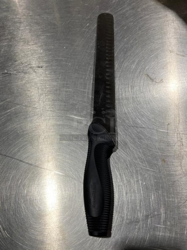 Dexter Russell DuoGlide stainless steel slicing knife, black grip handle, commercial grade, new condition.