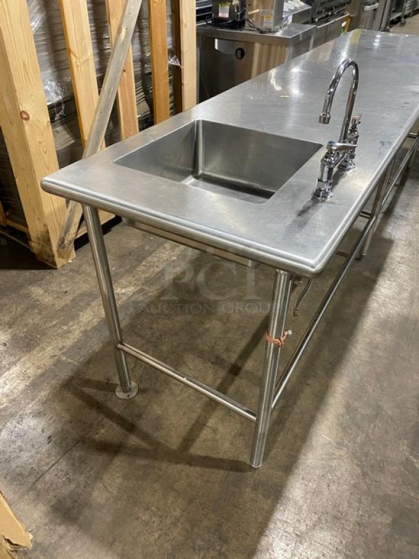 Commercial stainless steel prep table with right-side sink and faucet, pull-out drawer, and leg support. Ideal for kitchens.
