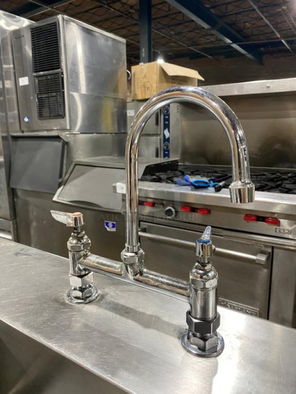 Commercial stainless steel worktop prep table with sink and faucet, featuring a single compartment, pull-out drawer, on sturdy legs.