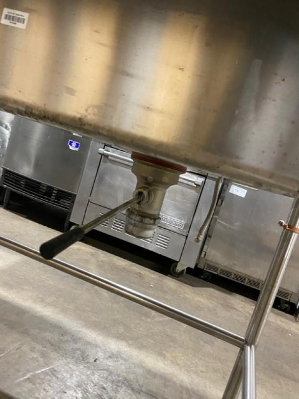 Commercial stainless steel prep table with open base, right-side sink with faucet, pull-out drawer, on sturdy legs.