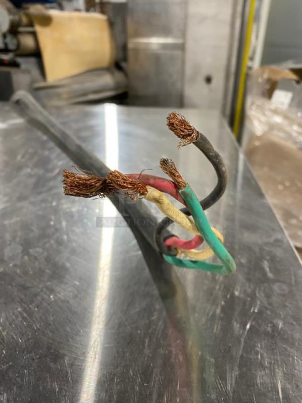 Frayed electrical wires on a stainless steel surface, likely part of the Market Forge ET-3E pressure steamer unit.
