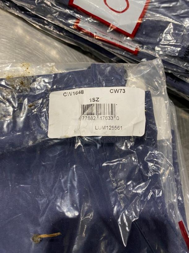 New Chefwear navy-blue apron, model CW1648-CW73, one size, 2 pockets, sealed packaging with barcode and size label visible.