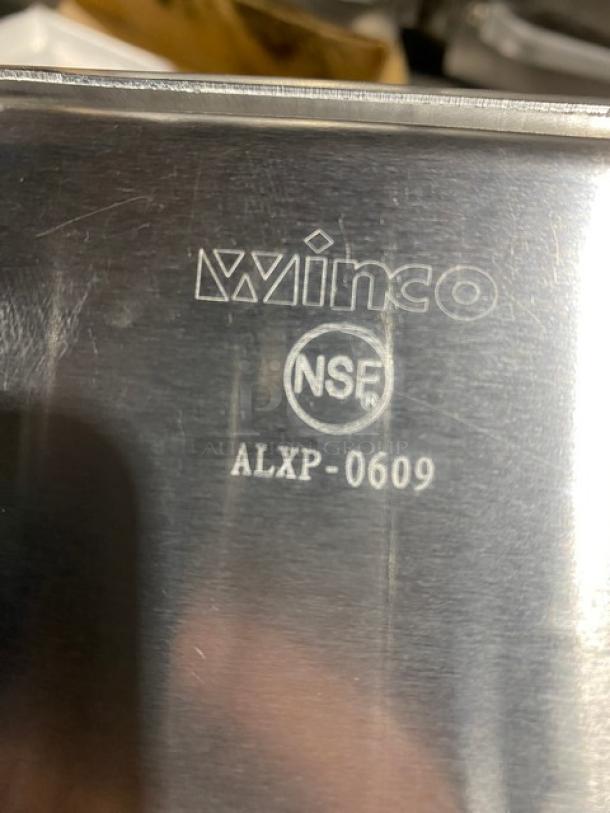 New Winco ALXP-0609 aluminum 1/8-size bun pan, NSF certified. Features visible Winco logo and model marking.