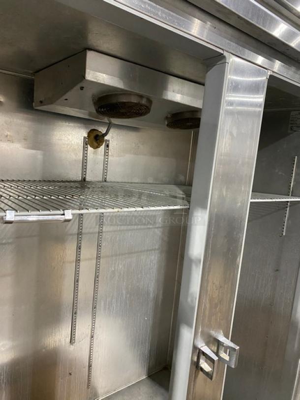 Continental 2F commercial 2-door reach-in freezer, stainless steel, with pan slides, poly-coated wire racks, on casters.