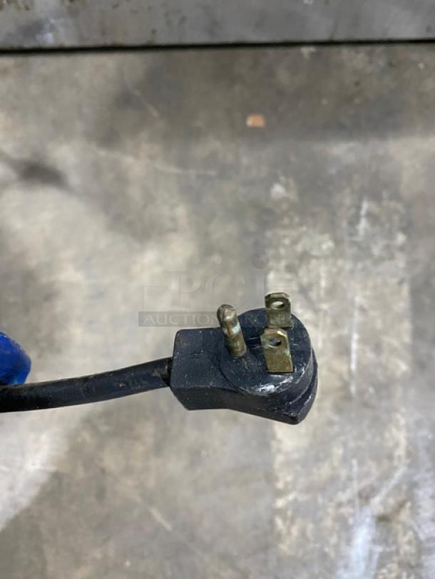Close-up of a power plug for a Beverage-Air stainless steel undercounter refrigerator, 115V, on casters.