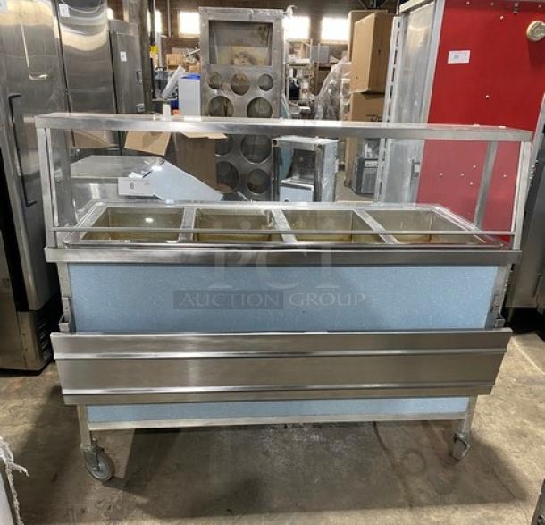 Atlas Metal 4-well stainless steel steamtable with sneeze guard, folding tray slide, and casters. Model WIH-D&M-4, 208V, 1-phase.