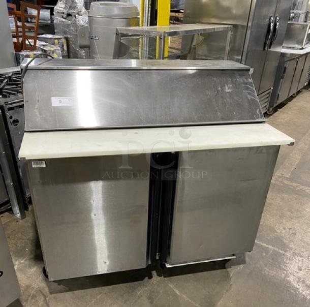 Silver King stainless steel 2-door refrigerated prep table, model SKEPT4812SD1BM, with cutting board, on casters.