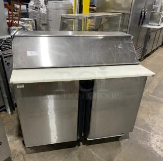 Silver King stainless steel 2-door refrigerated prep table, model SKEPT4812SD1BM, with cutting board, on casters.