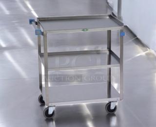 Stainless steel 3-tier utility cart in outstanding condition. Heavy-duty, fully tested, smooth-rolling wheels, blue handles.