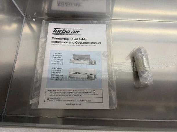 Turbo Air CTST Series countertop salad/prep table, flawless condition, brand new. Manual visible with potential models.