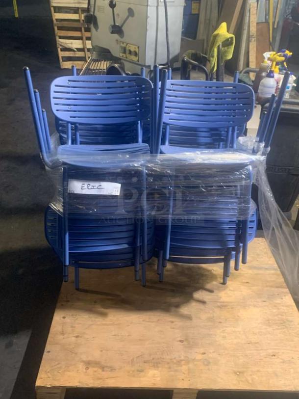 Set of stackable blue metal café chairs in pristine condition, wrapped in plastic on a wooden pallet. Tags show "EBTC."