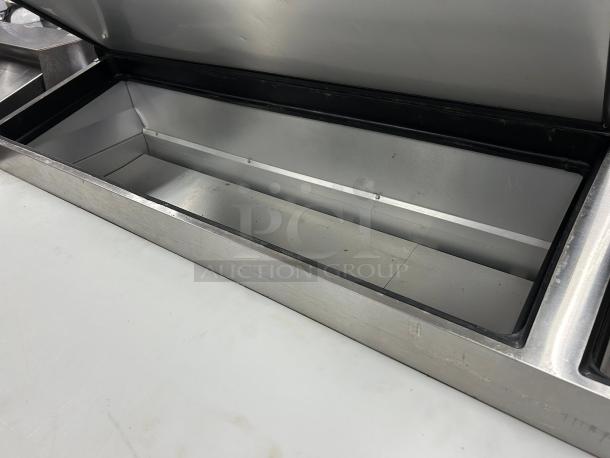 True TPP-AT-67-HC 67" pizza prep table, stainless steel, refrigerated base, tested and working, interior view.